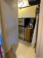 Compact Danby Silhouette fridge inside storage closet