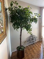 Full view of artificial tree in hammered copper pail