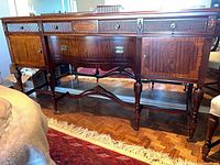 Front view showing drawers, cabinet doors, legs, hardware