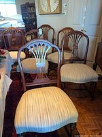 Group of six matching wood dining chairs with upholstered seats