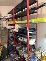 Full view of both connected shelving units with red frames and black shelves