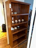 Front view of full shelving unit showing shelves and veneer finish