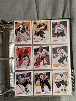 Fronts of nine 2008-09 Upper Deck Victory hockey cards in binder sheet