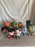 Group shot of ten loose Funko Pop figures standing on a cloth backdrop