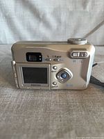 Rear view of Pentax Optio 330GS digital camera showing LCD, controls, optical viewfinder, wrist strap