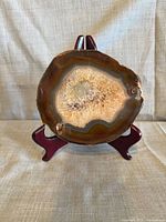 Front view showing polished face, banding and quartz druzy center