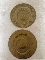 Front view of both brass plates showing designs and patina