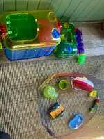 Two-level cage, carry cage, playpen with accessories arranged