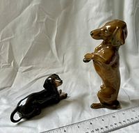 Both Rosenthal dachshund figurines side by side with ruler for scale