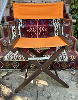 Full view of folded-out director’s chair showing canvas and frame