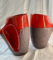 Front view of both Laurentian fat lava mugs with ruler showing height about 6 in