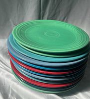 Stack of 12 multicolored Fiesta plates