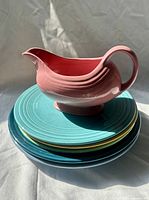 Stack of five plates topped with gravy boat