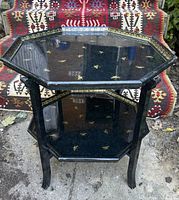Full view of octagonal foldable side table showing top and lower shelf