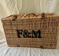 Front view of wicker hamper showing F&M logo