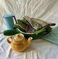 Group shot showing moka pot, fondue pot, teapot, towels, serving plate