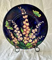 Full front view of the Maling Delphiniums plate on stand