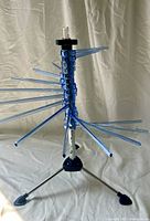 Full view of rack with arms partially opened showing tripod legs