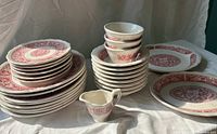 Stacked plates, bowls, platters and jug showing full lot