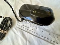 Top view of Bakelite body with cord and ruler for scale
