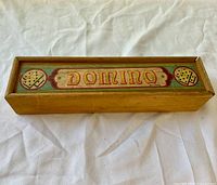 top view of wooden domino case with Domino label