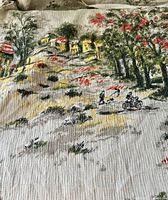 Close view of fabric print with houses, trees, figures on motorbike
