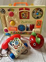 All three Fisher-Price toys grouped: Activity Center, Chatter Telephone, Happy Apple