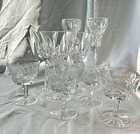 All stemware and candlesticks grouped on cloth backdrop