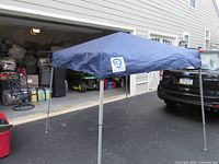 Full view of erected navy blue pop-up canopy showing frame and roof