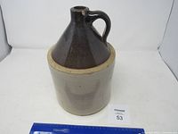 Overall view of jug seated inside crock