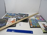 Overall lot showing DVDs, CD set, magazine, yardstick and ruler