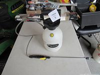 Full view of Flo-Master sprayer showing tank, pump cap, hose and wand