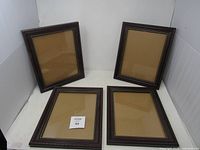 All four matching wooden picture frames displayed upright and flat