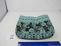 Full view of quilted cotton paisley bag with ruler for scale