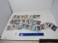 Wide view of spread out baseball cards on tabletop with ruler for scale