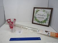 Overall lot: vase, shrink-wrap roll, framed sign