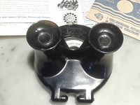 Black bakelite View-Master viewer with eyepieces, reel and leaflets visible