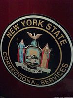 Close-up of New York State Correctional Services seal on magnet