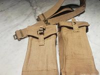 Two khaki Bren pouches attached together with part of web belt visible
