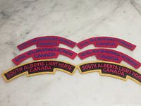 All six shoulder title patches displayed on marble surface