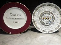 Two collectible plates side by side showing full fronts