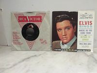 Both records with their respective sleeves displayed