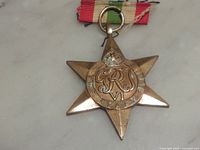 Front of Italy Star medal showing obverse detail and ribbon
