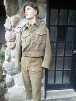 Full mannequin view wearing blouse, trousers and beret
