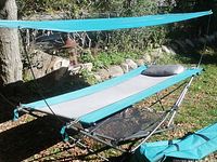 Hammock on stand with canopy, pillow, mesh basket visible