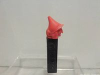 Full dispenser showing witch head and black stem