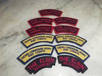 All eleven shoulder patches arranged on marble surface