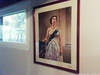 Framed signed portrait hanging on wall