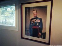 Full view of framed Prince Philip portrait on wall