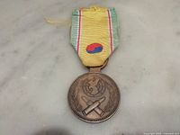 Full view of medal front and ribbon